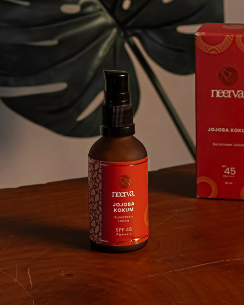 Neerva bottle and box on a wooden surface with a leaf in the background